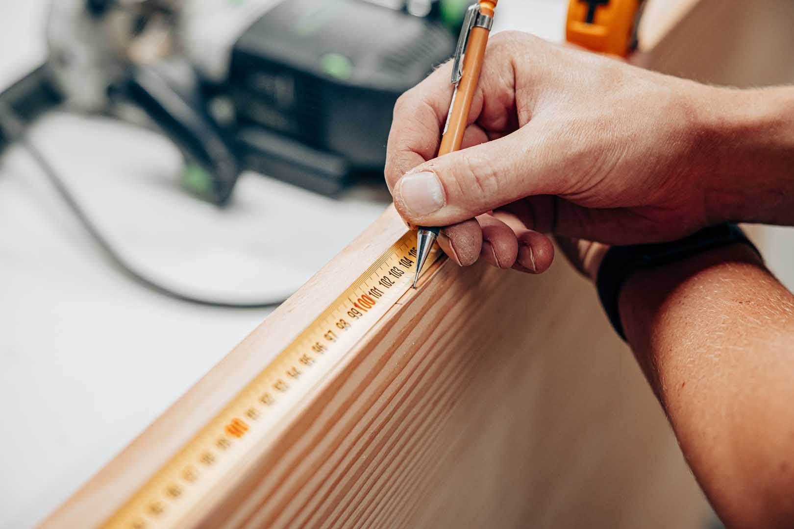 Close-up,Of,A,Hand,Marking,A,Wooden,Board,With,A